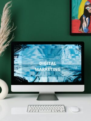 A contemporary office desk with computer screen showcasing digital marketing content.